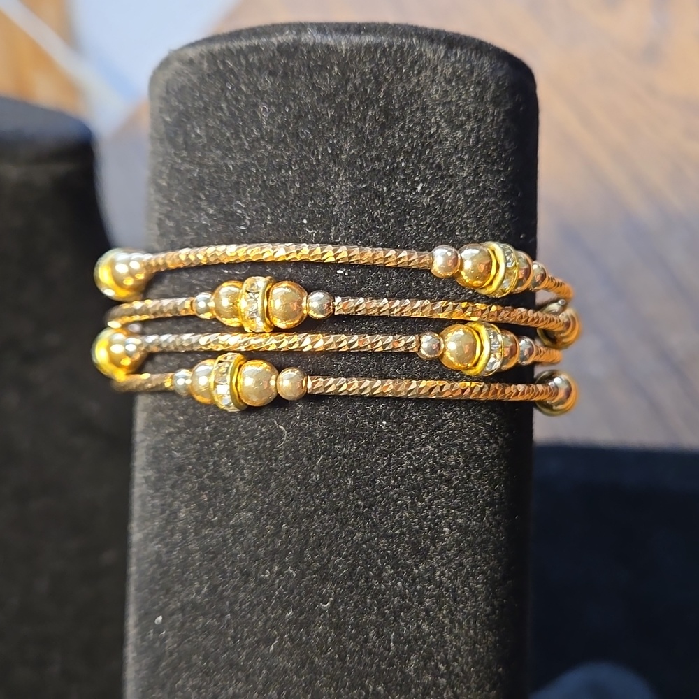 Boutique gold tone and crystal adjustable bangle.